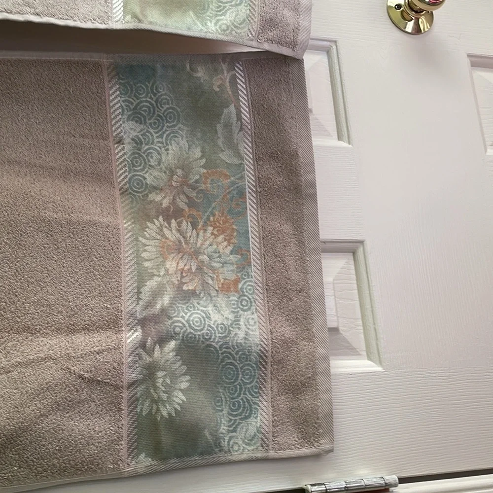 decorative hand towel embroidered at the bottom with floral pattern.